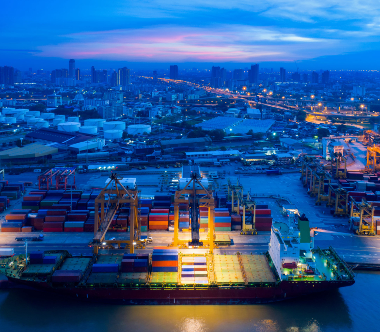 Containers yard in port congestion with ship vessels are loading and discharging operations of the transportation in international port.Shot from drone.